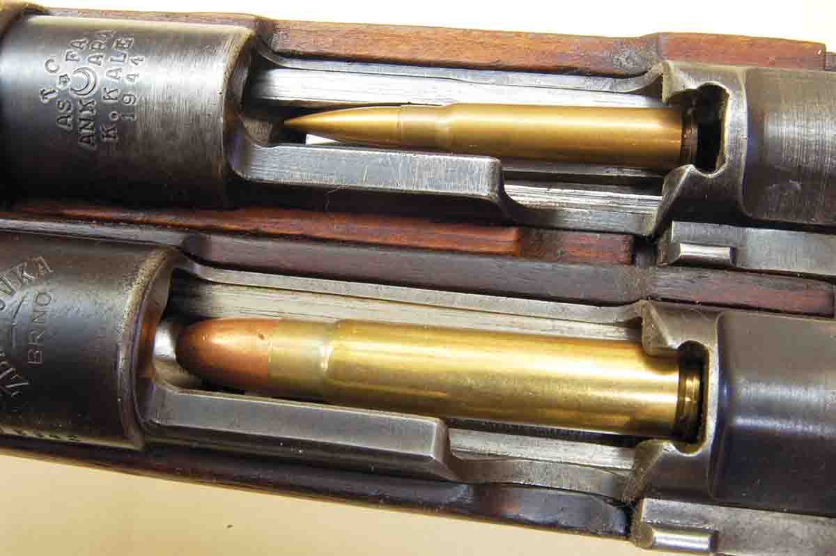 A standard size M98 action and 8x57mm cartridge (top). The 12.7x70mm (bottom) shows it is the largest round that can be made to fit the action.